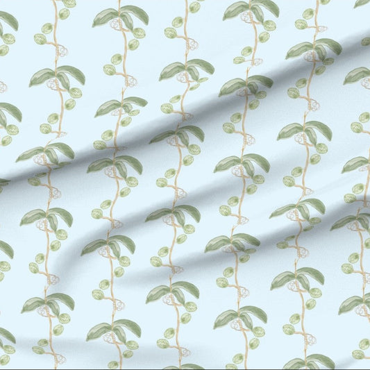 Fabric with green leaf flower pod vine pattern on a light blue background