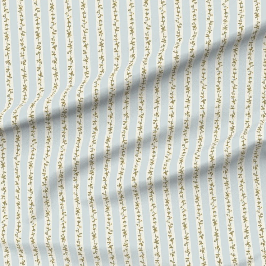 Fabric with floral vine vertical stripes on a blue background